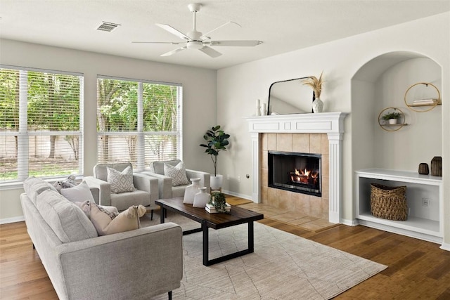 3416 Oxsheer Dr, Austin, TX 78732 - living area featuring light wood-style floors, ceiling fan, and a fireplace
