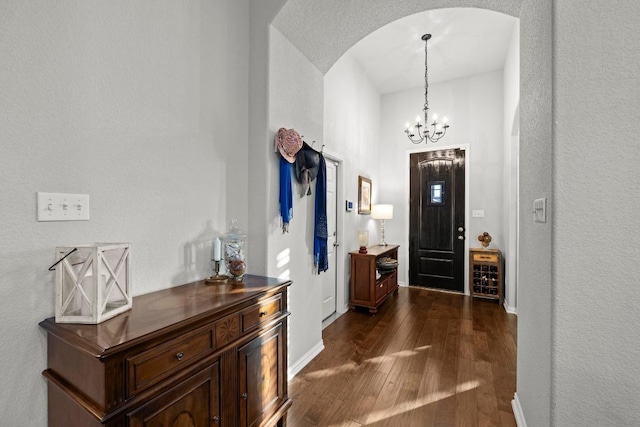 232 Mandana St, Leander, TX 78641 - foyer entrance with arched walkways, dark wood-style floors, and a chandelier