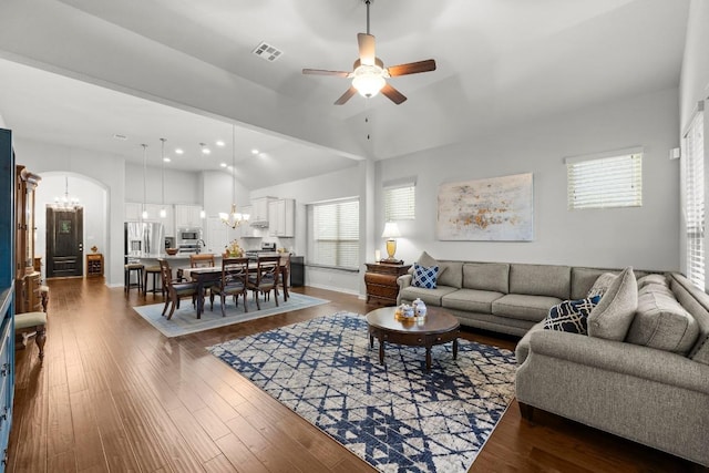 232 Mandana St, Leander, TX 78641 - living area with a chandelier, a ceiling fan, arched walkways, dark wood-type flooring, and a towering ceiling