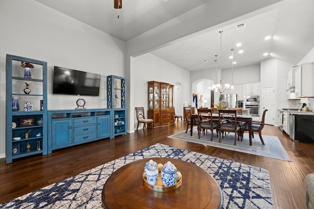 232 Mandana St, Leander, TX 78641 - living area with dark wood-style flooring, a chandelier, arched walkways, ceiling fan, and high vaulted ceiling