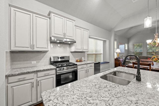 232 Mandana St, Leander, TX 78641 - kitchen with gas range, under cabinet range hood, vaulted ceiling, backsplash, and plenty of natural light