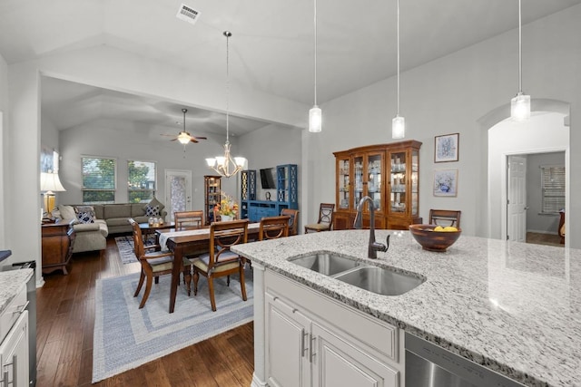 232 Mandana St, Leander, TX 78641 - kitchen with stainless steel dishwasher, a ceiling fan, dark wood-type flooring, light stone countertops, and high vaulted ceiling