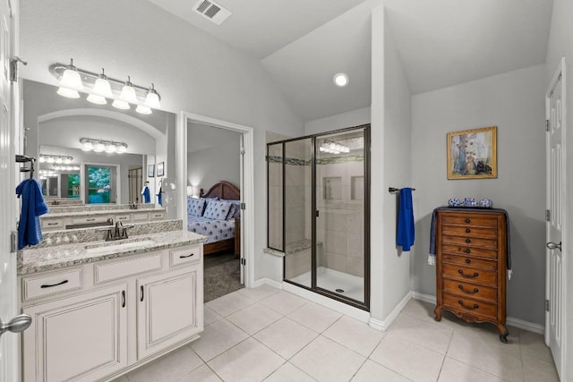 232 Mandana St, Leander, TX 78641 - ensuite bathroom featuring tile patterned flooring, vanity, a shower stall, and lofted ceiling