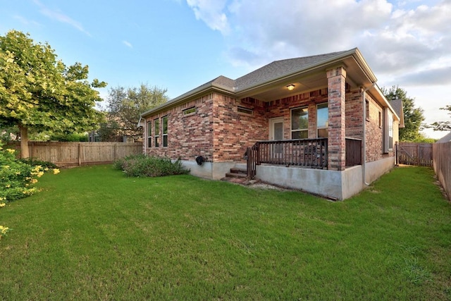 232 Mandana St, Leander, TX 78641 - rear view of property featuring a fenced backyard, brick siding, and a porch