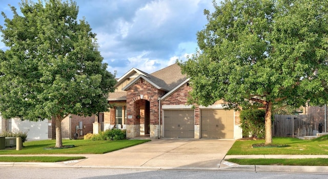 232 Mandana St, Leander, TX 78641 - view of front of home with brick siding, concrete driveway, an attached garage, stone siding, and a shingled roof