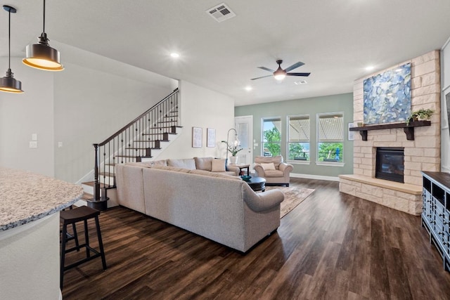 1329 Siena Sunset Rd, Leander, TX 78641 - living room with dark wood-type flooring, ceiling fan, stairs, a fireplace, and recessed lighting
