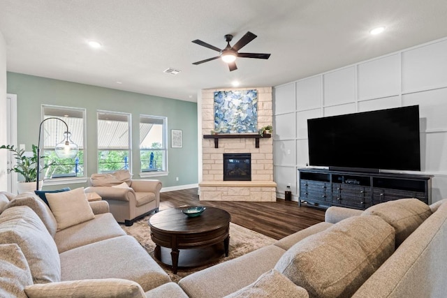 1329 Siena Sunset Rd, Leander, TX 78641 - living room featuring wood finished floors, a ceiling fan, recessed lighting, and a stone fireplace