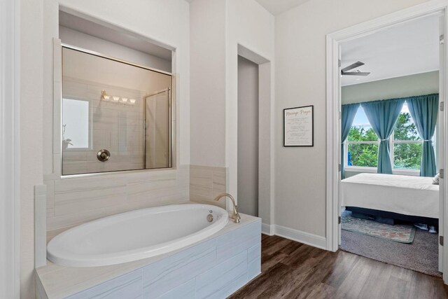 1329 Siena Sunset Rd, Leander, TX 78641 - full bathroom with a bath, ensuite bathroom, wood finished floors, and a tile shower