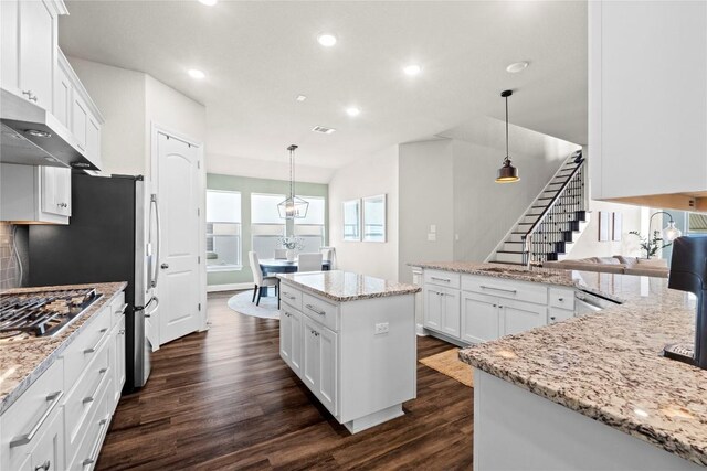 1329 Siena Sunset Rd, Leander, TX 78641 - kitchen featuring dark wood finished floors, recessed lighting, white cabinets, stainless steel appliances, and a kitchen island