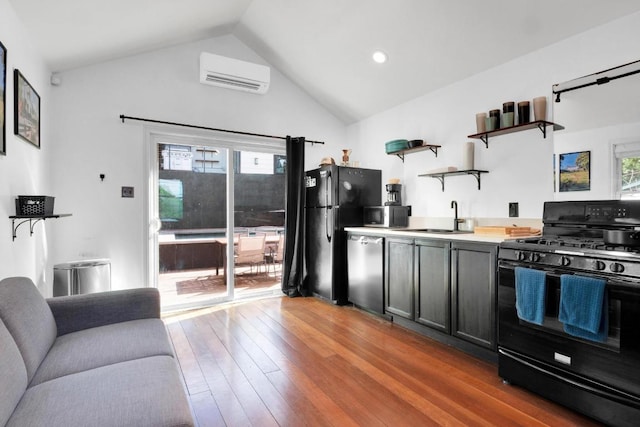 1914 E 8th St, Austin, TX 78702 - kitchen with black appliances, open shelves, a wall mounted air conditioner, healthy amount of natural light, and lofted ceiling