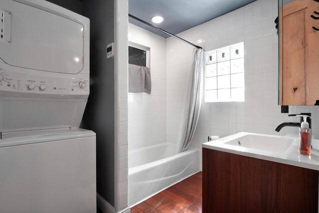 1914 E 8th St, Austin, TX 78702 - bathroom featuring estacked washer and dryer, shower / bath combination with curtain, wood finished floors, and vanity
