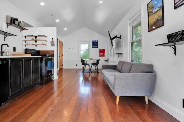 1914 E 8th St, Austin, TX 78702 - living area with hardwood / wood-style floors, lofted ceiling, and bar