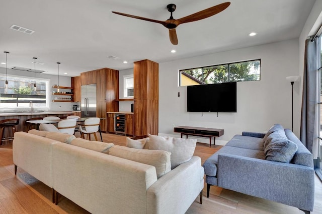 1914 E 8th St, Austin, TX 78702 - living room with light wood finished floors, recessed lighting, ceiling fan, and wine cooler