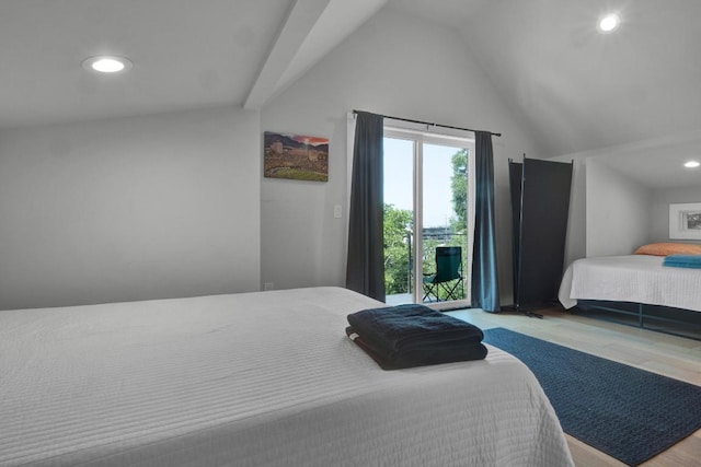 1914 E 8th St, Austin, TX 78702 - bedroom featuring wood finished floors, recessed lighting, vaulted ceiling, and access to outside