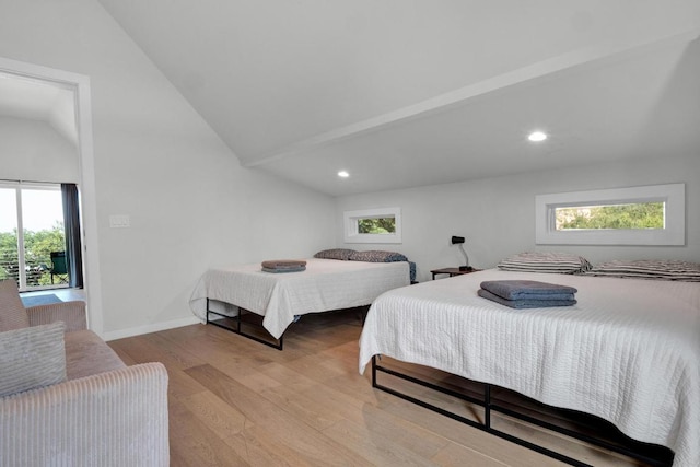 1914 E 8th St, Austin, TX 78702 - bedroom with vaulted ceiling, wood finished floors, multiple windows, and recessed lighting