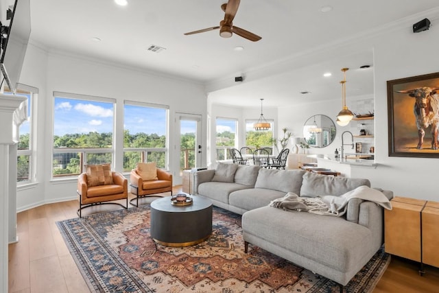 18113 Travis Dr, Lago Vista, TX 78645 - living area with healthy amount of natural light, a ceiling fan, ornamental molding, recessed lighting, and wood finished floors
