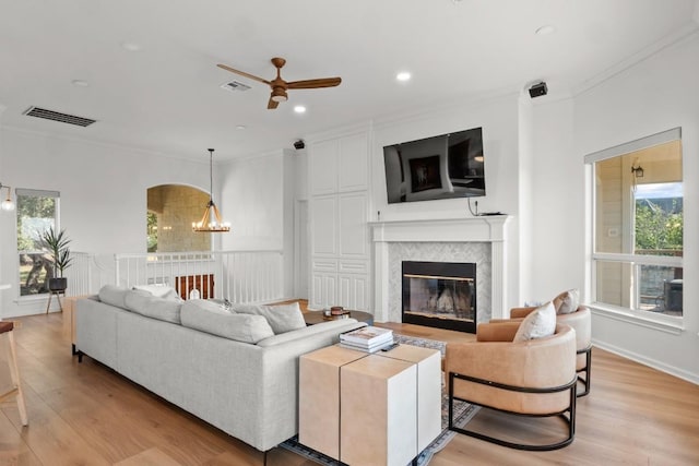 18113 Travis Dr, Lago Vista, TX 78645 - living room with crown molding, ceiling fan, a chandelier, light wood-style flooring, and recessed lighting