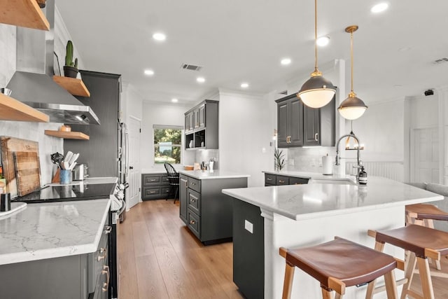 18113 Travis Dr, Lago Vista, TX 78645 - kitchen with open shelves, exhaust hood, electric range, gray cabinetry, and recessed lighting