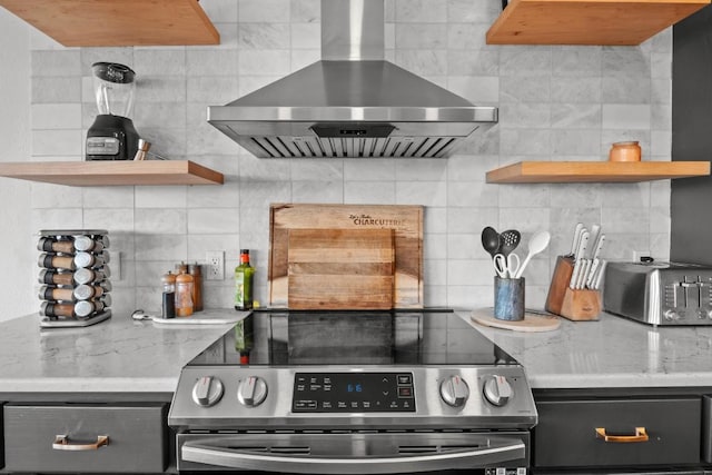 18113 Travis Dr, Lago Vista, TX 78645 - kitchen featuring stainless steel range with electric stovetop, wall chimney range hood, open shelves, and decorative backsplash