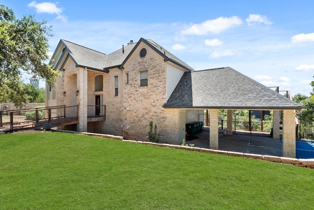 18113 Travis Dr, Lago Vista, TX 78645 - back of property with a shingled roof, stone siding, and a patio
