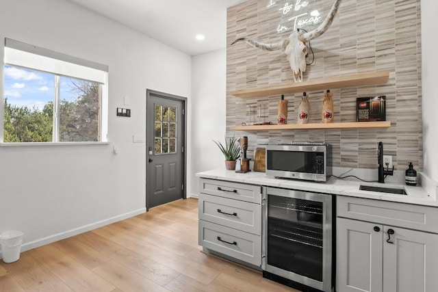 18113 Travis Dr, Lago Vista, TX 78645 - indoor dry bar with wine cooler, stainless steel microwave, plenty of natural light, decorative backsplash, and recessed lighting