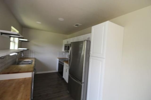 1109 W Lincoln Ave, Copperas Cove, TX 76522 - kitchen featuring appliances with stainless steel finishes, white cabinets, dark wood-type flooring, and butcher block countertops