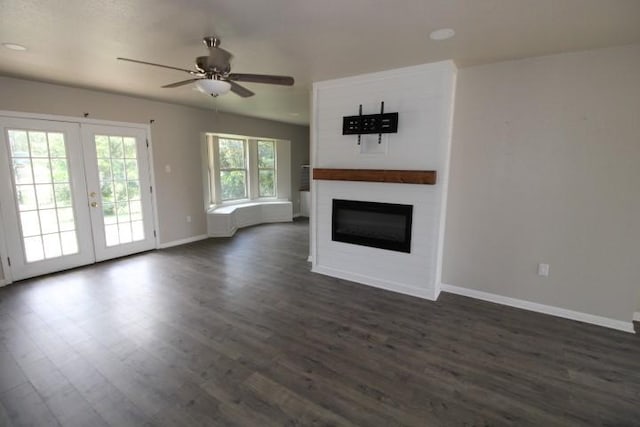 1109 W Lincoln Ave, Copperas Cove, TX 76522 - unfurnished living room featuring dark wood-type flooring, a glass covered fireplace, and french doors