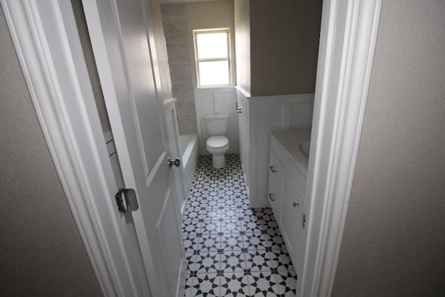 1109 W Lincoln Ave, Copperas Cove, TX 76522 - bathroom with tile patterned floors, vanity, wainscoting, and a decorative wall