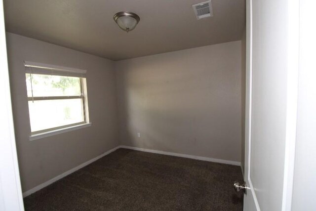 1109 W Lincoln Ave, Copperas Cove, TX 76522 - spare room featuring dark carpet and baseboards