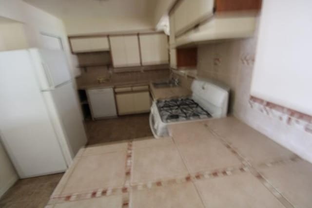 313 Elm St, Copperas Cove, TX 76522 - kitchen with white appliances and tile patterned flooring
