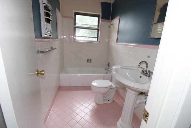 313 Elm St, Copperas Cove, TX 76522 - bathroom featuring tile walls, tile patterned flooring, bathing tub / shower combination, and a wainscoted wall