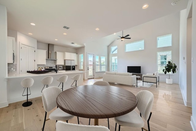 1531 N Red Bud Ln Unit 33, Round Rock, TX 78665 - dining room with light wood finished floors, ceiling fan, recessed lighting, and a towering ceiling