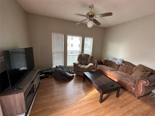 2414 Longview St Unit 301, Austin, TX 78705 - living area featuring light wood-style floors, a ceiling fan, and a textured ceiling