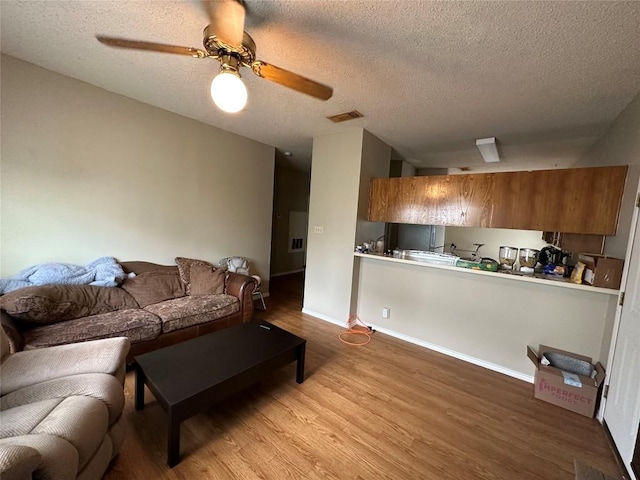 2414 Longview St Unit 301, Austin, TX 78705 - living area featuring wood finished floors, ceiling fan, and a textured ceiling
