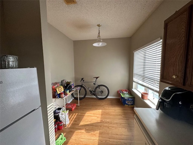 2414 Longview St Unit 301, Austin, TX 78705 - dining area with light wood finished floors and a textured ceiling