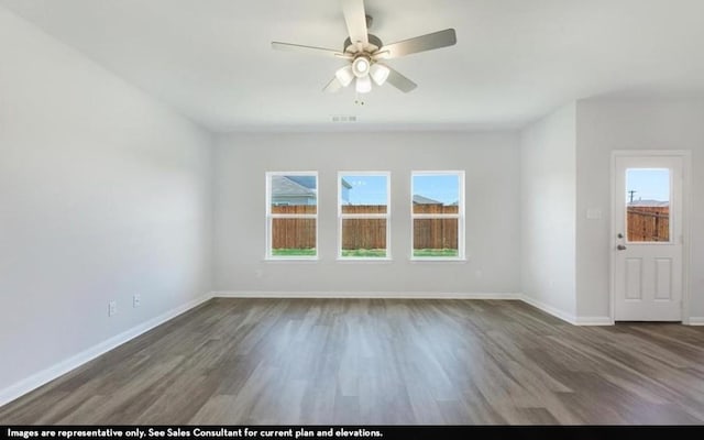 290 Yosemite Dr, Kyle, TX 78640 - unfurnished living room with plenty of natural light, wood finished floors, and ceiling fan