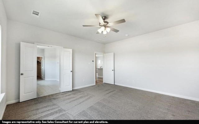 290 Yosemite Dr, Kyle, TX 78640 - unfurnished bedroom featuring carpet flooring and ceiling fan