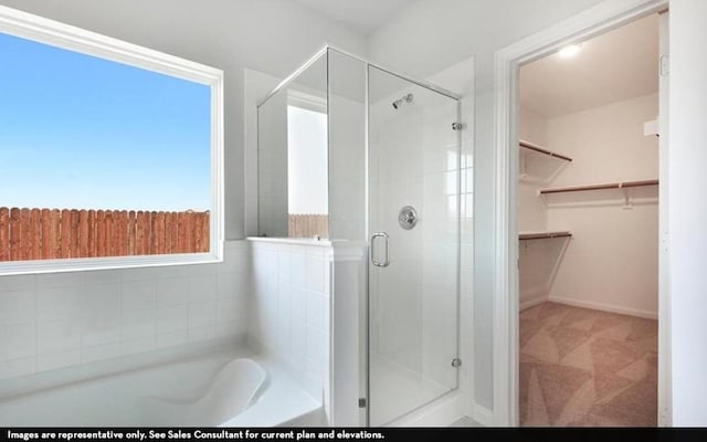 290 Yosemite Dr, Kyle, TX 78640 - bathroom featuring a stall shower, a bath, and a spacious closet