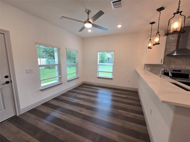 2105 Tiger Trl Unit 703, Round Rock, TX 78664 - unfurnished dining area featuring dark wood-type flooring, ceiling fan, and recessed lighting
