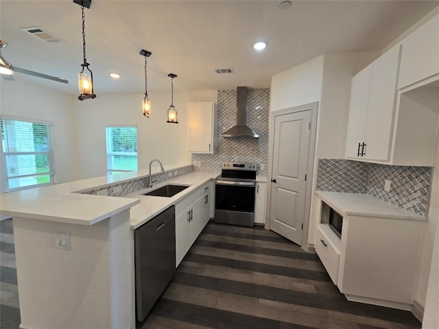 2105 Tiger Trl Unit 703, Round Rock, TX 78664 - kitchen featuring appliances with stainless steel finishes, wall chimney exhaust hood, a peninsula, tasteful backsplash, and dark wood-style floors