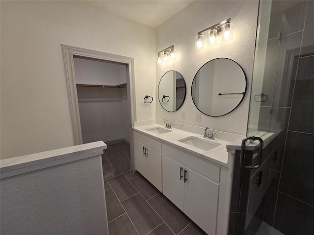 2105 Tiger Trl Unit 703, Round Rock, TX 78664 - full bath featuring double vanity, a spacious closet, and a shower stall