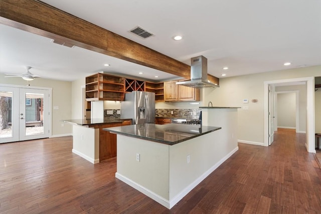 6202 Hillston Dr, Austin, TX 78745 - kitchen with stainless steel fridge, open shelves, island exhaust hood, dark countertops, and a peninsula
