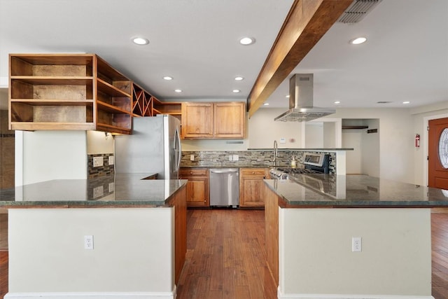 6202 Hillston Dr, Austin, TX 78745 - kitchen with stainless steel appliances, island exhaust hood, a peninsula, dark wood-style floors, and recessed lighting