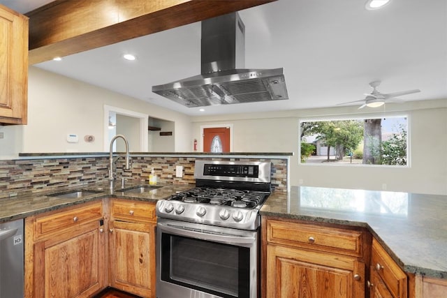 6202 Hillston Dr, Austin, TX 78745 - kitchen featuring stainless steel appliances, exhaust hood, backsplash, a peninsula, and dark stone countertops