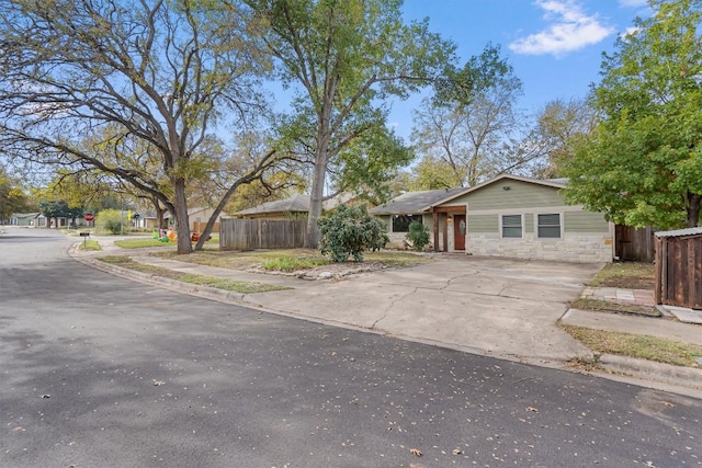 6202 Hillston Dr, Austin, TX 78745 - view of front of house featuring concrete driveway and stone siding