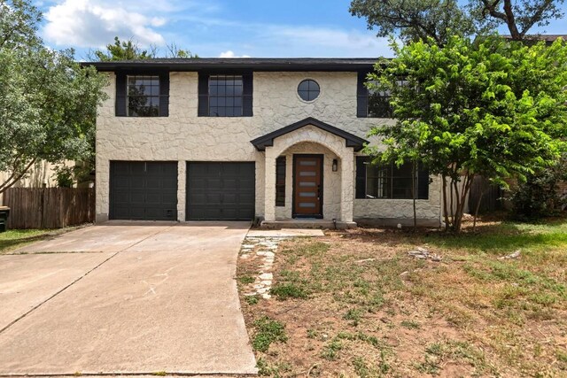 13265 Kerrville Folkway Dr, Austin, TX 78729 - view of front facade with concrete driveway, an attached garage, and stone siding