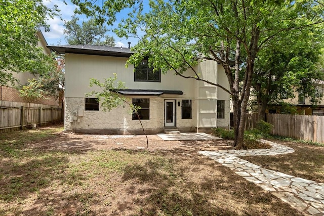 13265 Kerrville Folkway Dr, Austin, TX 78729 - rear view of property with a fenced backyard, entry steps, and a patio area