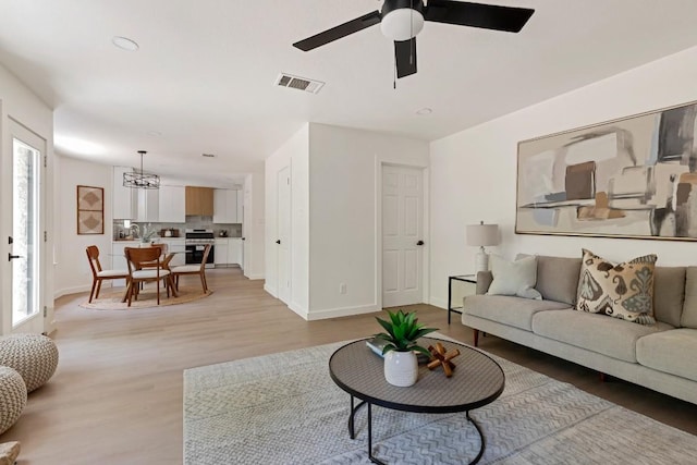 13265 Kerrville Folkway Dr, Austin, TX 78729 - living area with light wood-style flooring, a chandelier, and ceiling fan