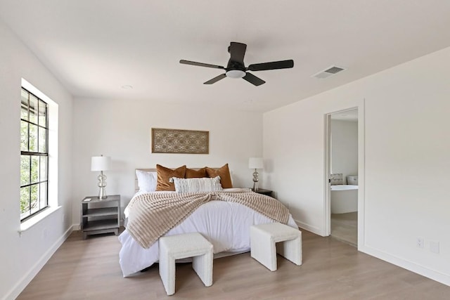 13265 Kerrville Folkway Dr, Austin, TX 78729 - bedroom with light wood finished floors, ceiling fan, and ensuite bathroom