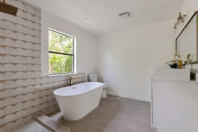 13265 Kerrville Folkway Dr, Austin, TX 78729 - bathroom with vanity, a freestanding tub, and tile patterned floors